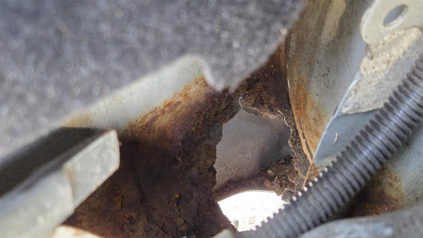 Corrosion hole through a trunk floor