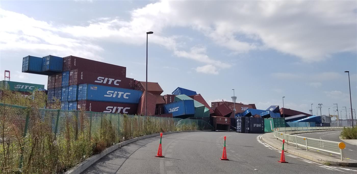 Shipping containers toppled across a closed port road after Typhoon Jebi